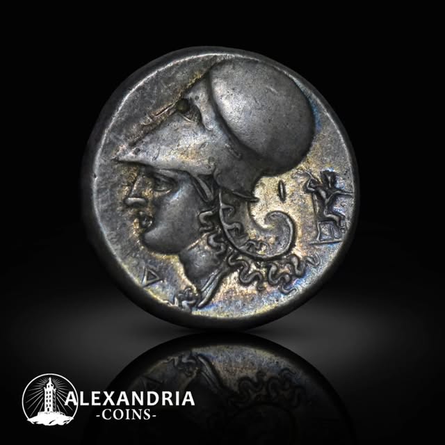 Ancient silver coin with helmeted Athena