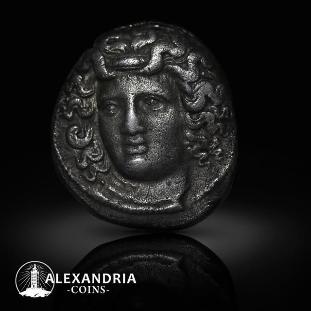 Ancient bronze coin with a facing head of Medusa